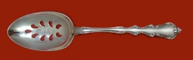 International Angelique Sterling Silver Pierced Serving Spoon 9 Hole Custom: International Angelique Sterling Silver Pierced Serving Spoon 9 Hole Custom Angelique by International is a sterling silver pierced serving spoon with a 9-hole design and an ornate handle. It is custo