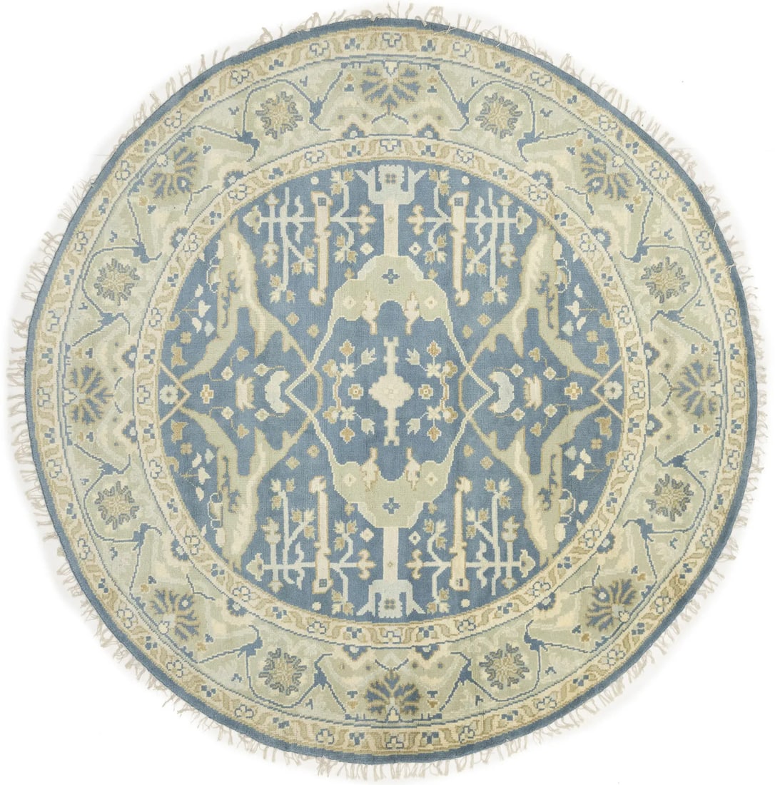 Round hand-knotted wool Oushak floral area rug 7'9 x 7'9: Round hand-knotted wool Oushak floral area rug 7'9 x 7'9 This round Oushak-style Oriental rug features a hand-knotted wool construction with a floral pattern in muted tones of blue-gray, cream, and be