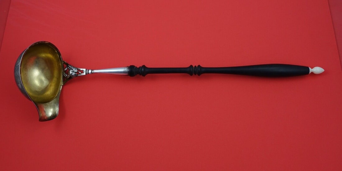 15 inch Danish Sterling punch ladle ebony wood handle silver: 15 inch Danish Sterling punch ladle ebony wood handle silver This Danish Sterling punch ladle is made of sterling silver and features an ebony wood handle with a vegetable ivory (plant based) finial. 