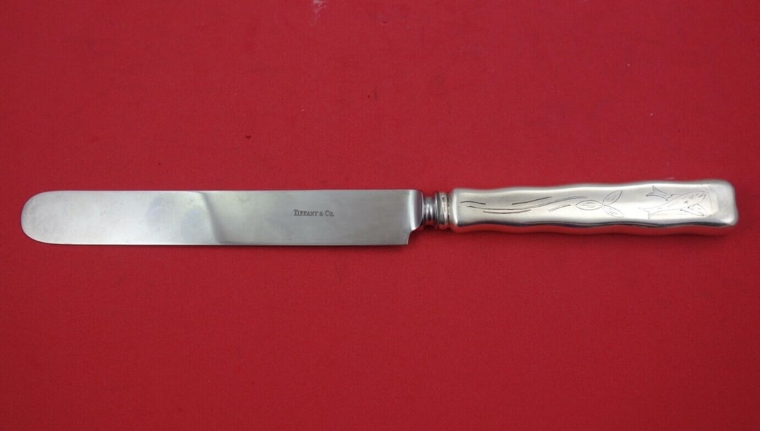 Tiffany & Co. Sterling Silver Dinner Knife Lap Over Edge Fish Design 10 1/4": Tiffany & Co. Sterling Silver Dinner Knife Lap Over Edge Fish Design 10 1/4" This elegant dinner knife from Tiffany & Co. features the classic Lap Over Edge pattern, crafted from high-quality sterling