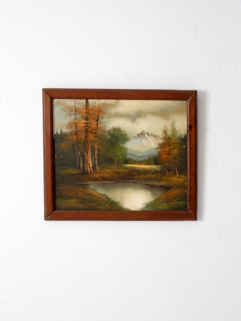 Vintage Mid-Century Landscape Oil Painting Signed 27.5 x 23.5 Inches: Vintage Mid-Century Landscape Oil Painting Signed 27.5 x 23.5 Inches This vintage mid-century landscape oil painting captures a serene mountain lake embraced by autumn foliage and distant mountain pea