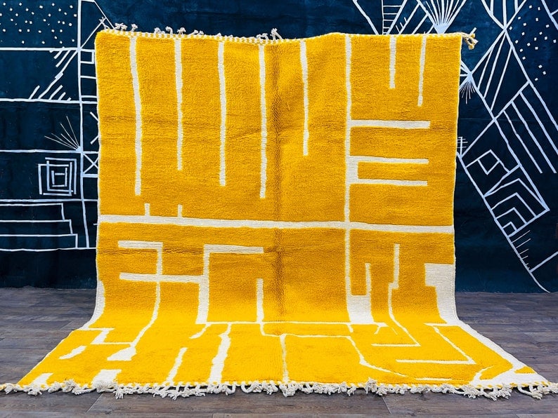 Authentic Yellow Handmade Engraved Wool Rug from Morocco: Authentic Yellow Handmade Engraved Wool Rug from Morocco This stylish yellow handmade engraved wool rug is a unique piece crafted by local Berber women weavers in the Atlas Mountains of Morocco. Made 