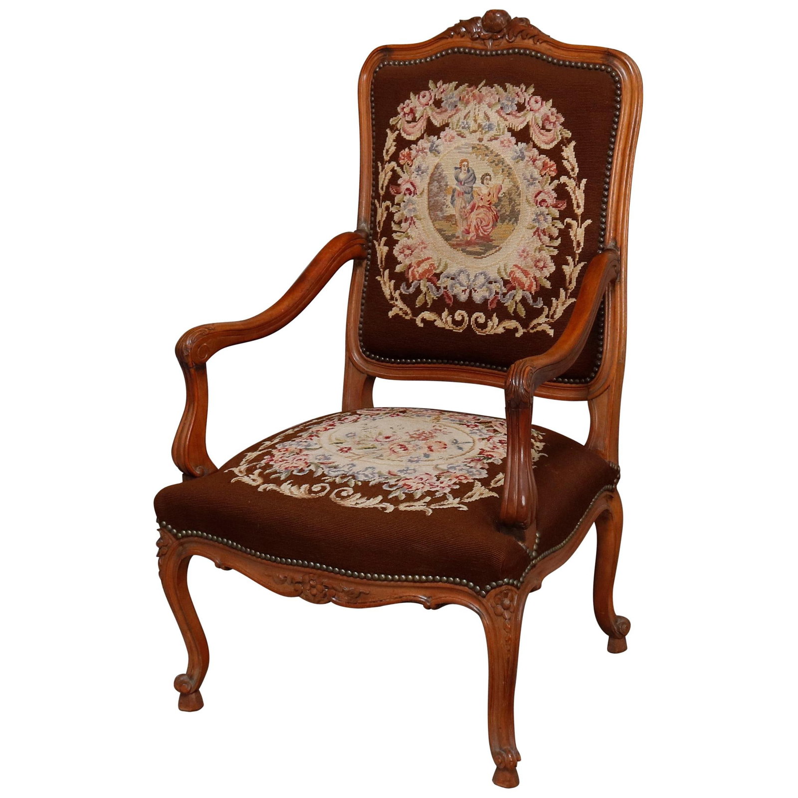 Antique Louis XV Fruitwood Fauteuil with Needlepoint Upholstery 1910: Antique Louis XV Fruitwood Fauteuil with Needlepoint Upholstery 1910 This exquisite antique French Louis XV fauteuil showcases a beautifully carved fruitwood frame, embodying the elegance of the Louis
