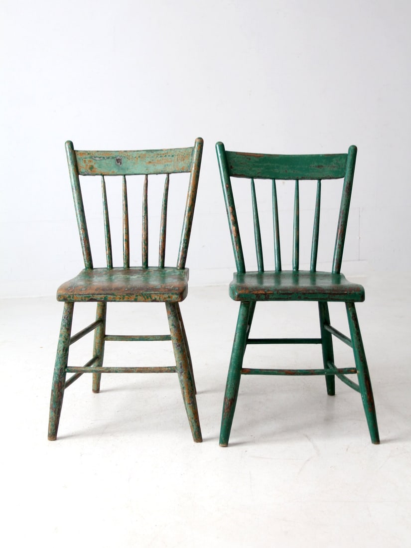Pair of Primitive Farmhouse Chairs with Plank Seats: Pair of Primitive Farmhouse Chairs with Plank Seats This charming pair of antique primitive farmhouse chairs showcases beautifully crafted wood plank seats and spindle backs, all adorned in a striking
