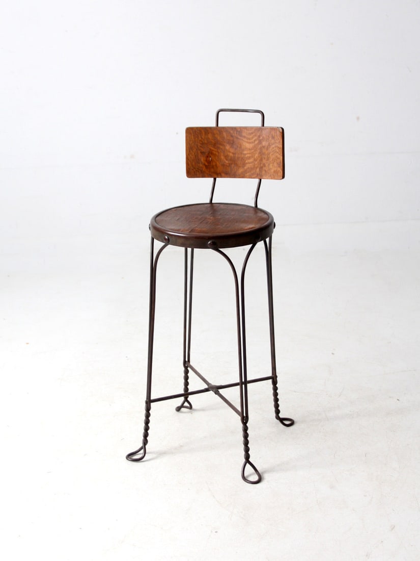 Vintage Twisted Wire Ice Cream Parlor Stool with Wood Seat: Vintage Twisted Wire Ice Cream Parlor Stool with Wood Seat This antique ice cream parlor stool showcases a charming twisted wire frame characteristic of classic designs. The round wood veneer seat con