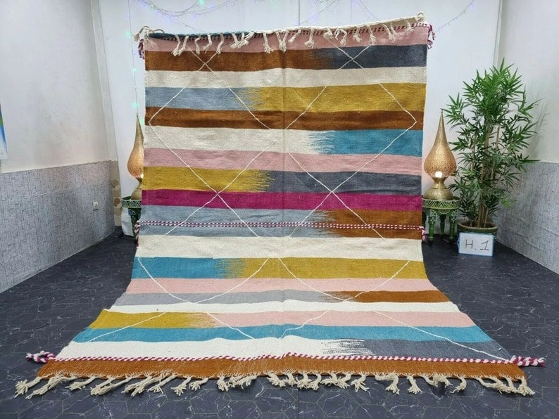 Authentic Handmade Moroccan Berber Wool Area Rug 9.84 x 6.56 Feet: Authentic Handmade Moroccan Berber Wool Area Rug 9.84 x 6.56 Feet Experience the beauty of traditional craftsmanship with this stunning authentic colorful handmade Moroccan Berber wool area rug. This 