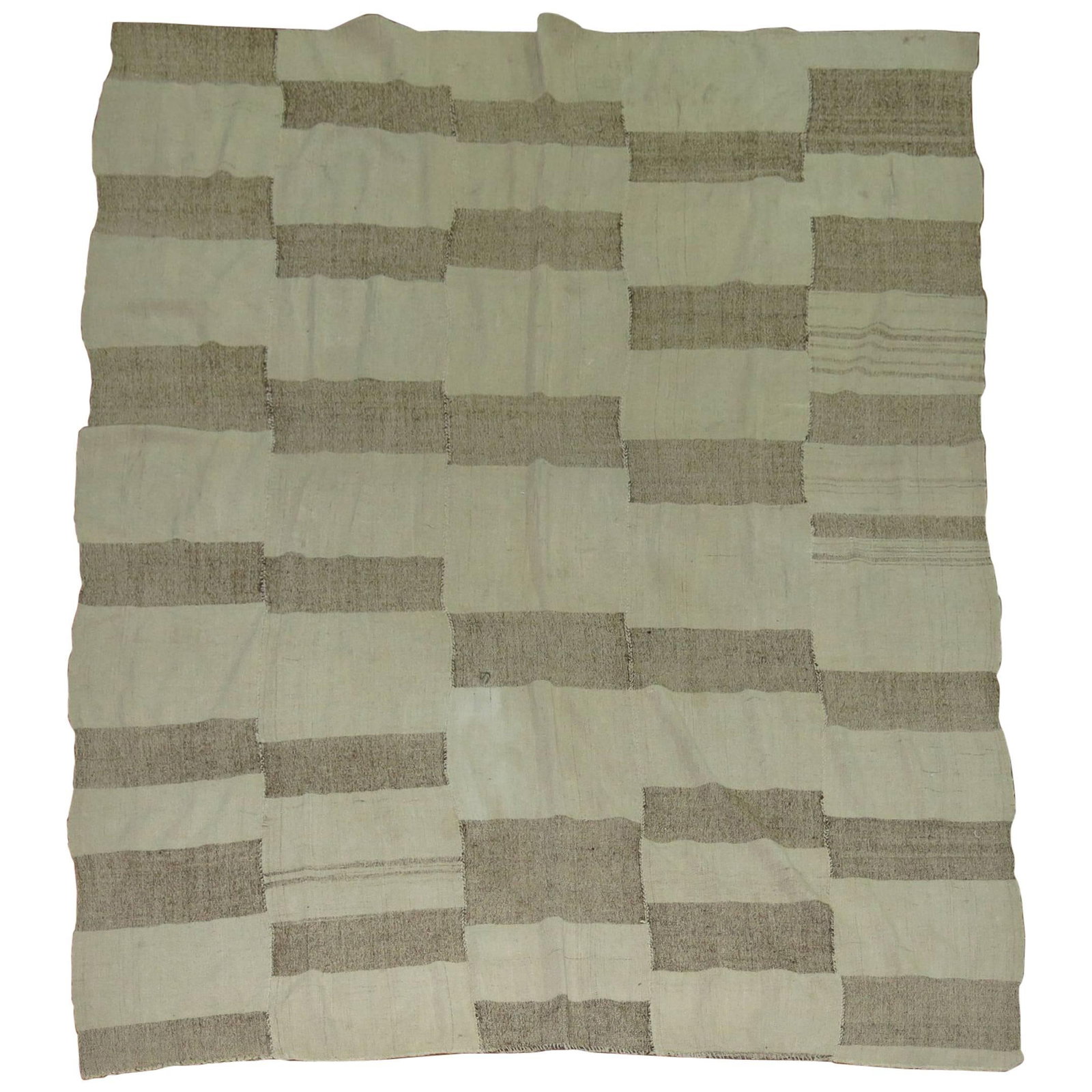 Turkish Wool Hand Knotted Kilim 77 in x 97 in: Turkish Wool Hand Knotted Kilim 77 in x 97 in This vintage Turkish Kilim from the 20th century features a minimalist design in khaki and brown tones. Hand-knotted from wool, it showcases traditional c
