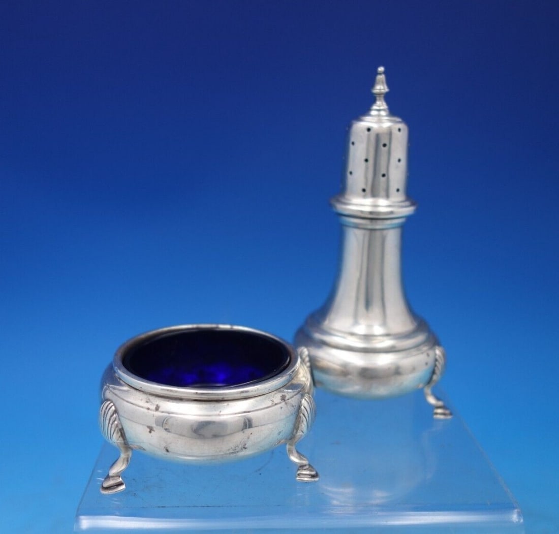 Mueck-Cary Shell Sterling Silver Salt Pepper Set 2pc with Cobalt Liner: Mueck-Cary Shell Sterling Silver Salt Pepper Set 2pc with Cobalt Liner Enhance your dining experience with this exquisite Shell Sterling Silver Salt and Pepper Set by Mueck-Cary. This two-piece set sh