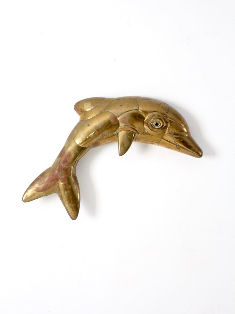 Brass-Plated Copper Dolphin Wall Art Mid-Century Segmented Sculpture: Brass-Plated Copper Dolphin Wall Art Mid-Century Segmented Sculpture This mid-century wall sculpture features a dolphin design crafted from brass-plated copper, formed into a segmented, sculptural sha