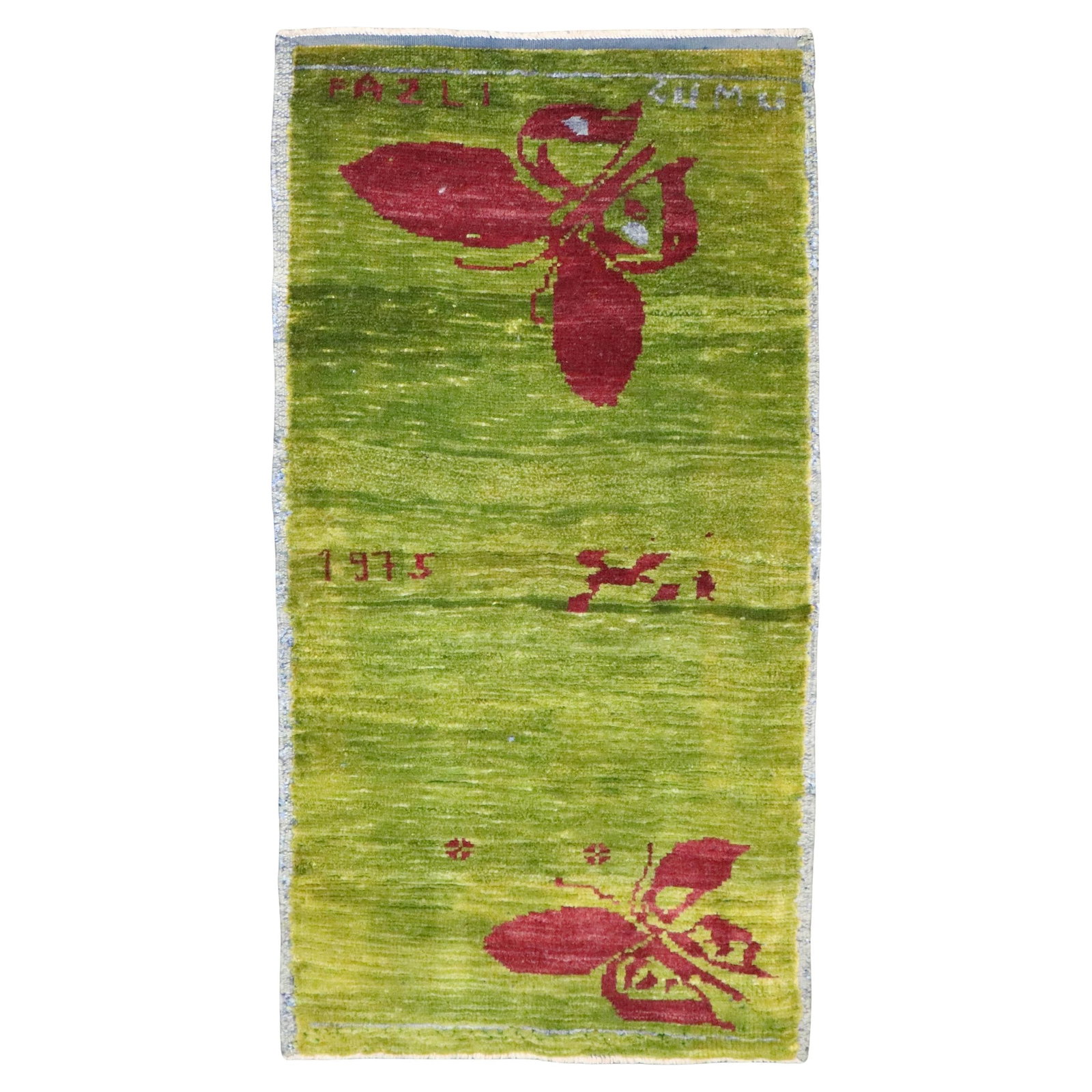 1975 Handwoven Green Anatolian Wool Rug with Butterfly Motif 22 x 41 Inches: 1975 Handwoven Green Anatolian Wool Rug with Butterfly Motif 22 x 41 Inches This vintage Turkish Anatolian rug features a distinctive green color and a butterfly design, hand-woven in 1975. The rug sh