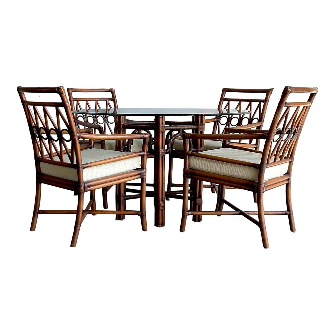 Five-Piece Rattan Dining Ensemble With Loop Back Chairs and Glass Top Table Set of 5: Five-Piece Rattan Dining Ensemble With Loop Back Chairs and Glass Top Table Set of 5 This vintage five-piece dining set exudes Mid-Century resort elegance, featuring a substantial round table with a c