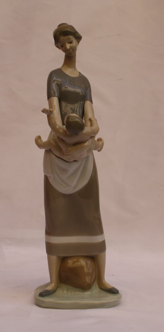 Lladro Hand Painted Porcelain Mother and Baby Figurine 13 Inches: Lladro Hand Painted Porcelain Mother and Baby Figurine 13 Inches This exquisite hand-painted porcelain figurine by Lladro depicts a tender moment between a mother and her baby. The piece showcases exc