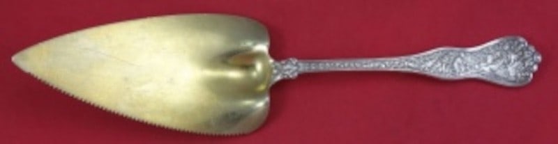 Tiffany Co Olympian Sterling Silver Pie Server Gold Washed Serrated 10 3/4: Tiffany Co Olympian Sterling Silver Pie Server Gold Washed Serrated 10 3/4 Sterling silver cake/pie server in the Olympian pattern by Tiffany & Co. It features a hollow handle, gold-washed serrated bl