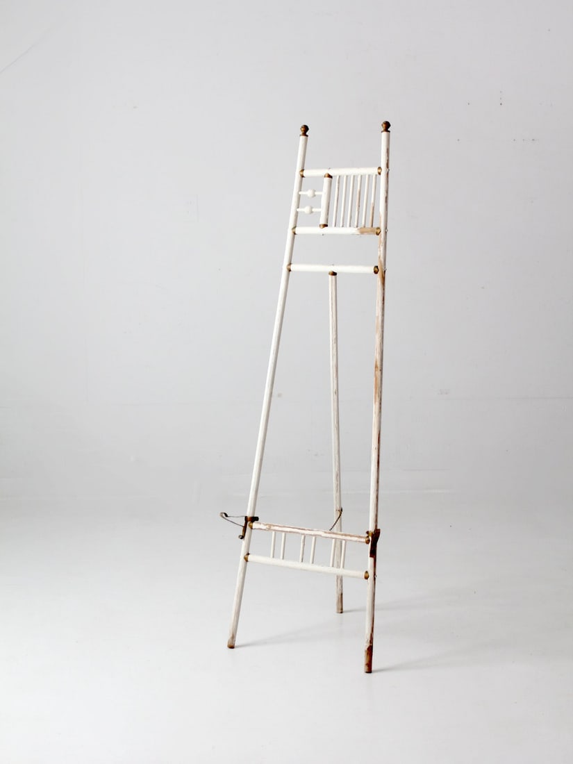 Victorian Antique Ball And Stick Easel with Gold Accents: Victorian Antique Ball And Stick Easel with Gold Accents This antique ball and stick easel is an elegant piece from the Victorian era, perfect for showcasing art. It features beautifully aged white pa
