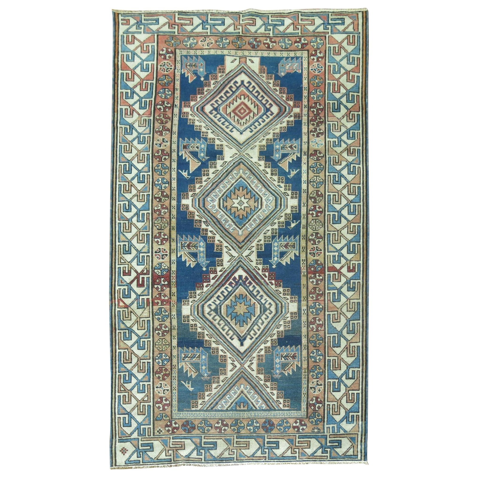 Hand-Woven Wool Kazak Rug 37 x 61 in Caucasus: Hand-Woven Wool Kazak Rug 37 x 61 in Caucasus This early 20th century Kazak rug features a striking geometric pattern in blue and cream tones. Hand-woven from wool, it reflects traditional Caucasian c