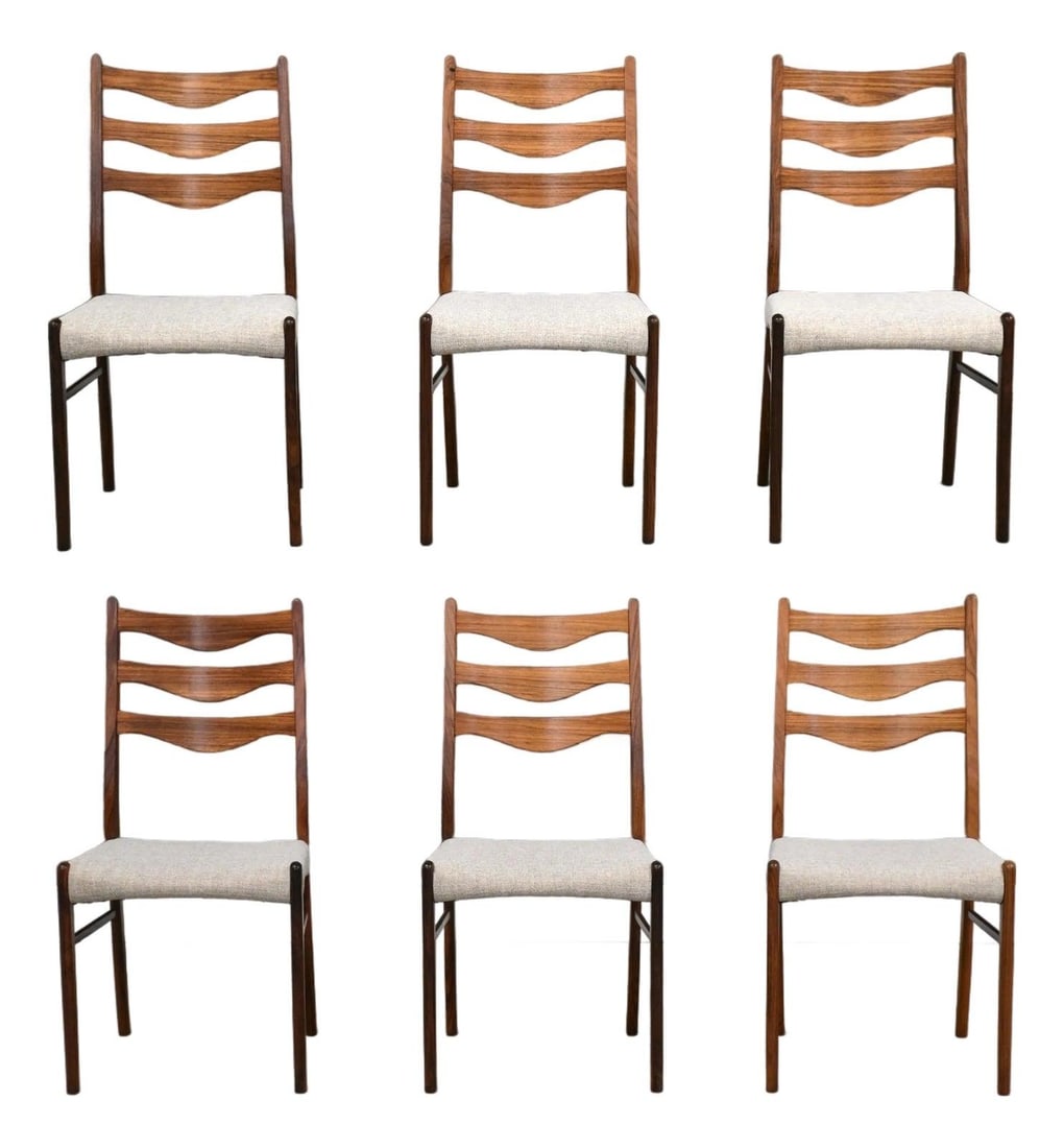Set of 6 Danish Rosewood Dining Chairs by Arne Wahl Iversen: Set of 6 Danish Rosewood Dining Chairs by Arne Wahl Iversen This set includes six mid-century modern dining chairs designed by Arne Wahl Iversen and crafted in Denmark from rosewood. The chairs featur
