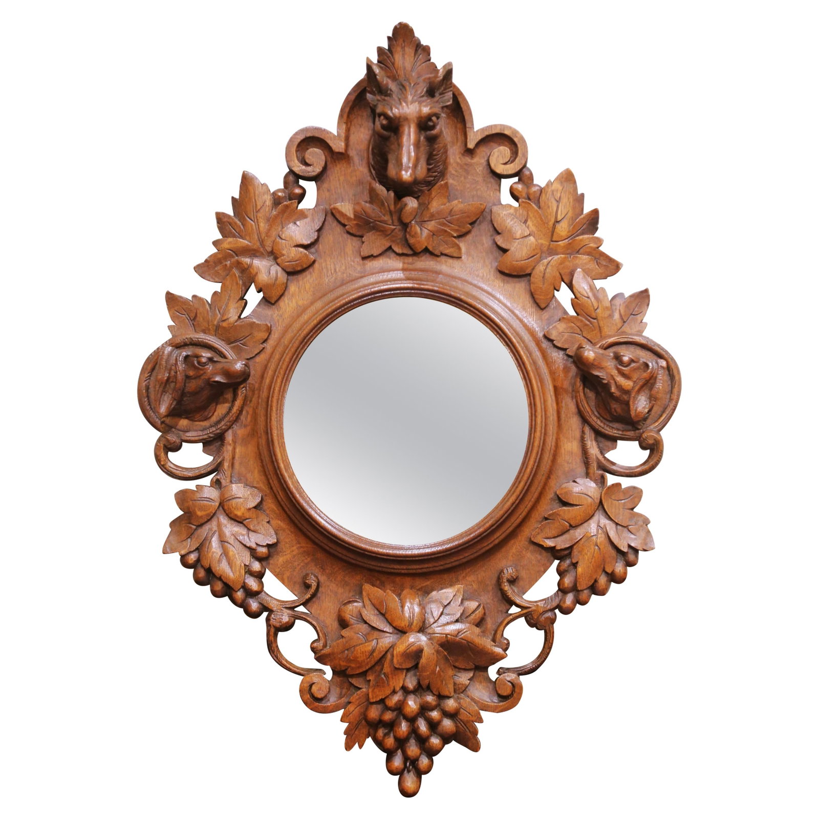 French Black Forest Oak Hunting Motif Wall Mirror: French Black Forest Oak Hunting Motif Wall Mirror This late 19th-century French Black Forest wall mirror features an oval mirror set within an elaborately hand-carved oak frame. The frame is richly ad