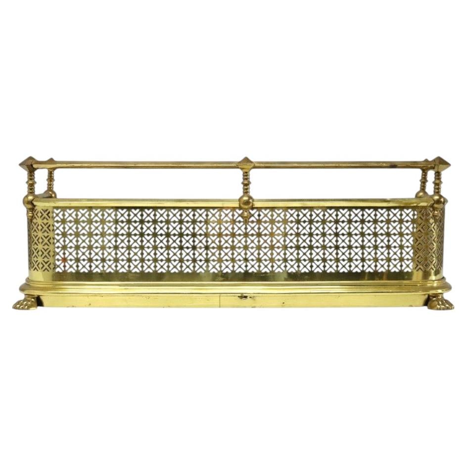 c1920 Brass Fireplace Fender Screen with Paw Feet: c1920 Brass Fireplace Fender Screen with Paw Feet Antique brass fireplace fender dating to approximately 1920, with a rectangular form and an intricately perforated geometric front panel featuring a r