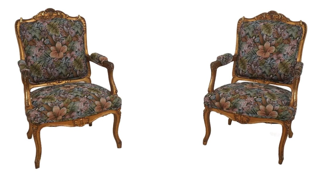 French Giltwood Fauteuil Armchairs Pair Floral Upholstery: French Giltwood Fauteuil Armchairs Pair Floral Upholstery This pair of Louis XV style giltwood fauteuil armchairs features finely carved ornate details, Queen Anne legs with pad feet, and gold gilt fr