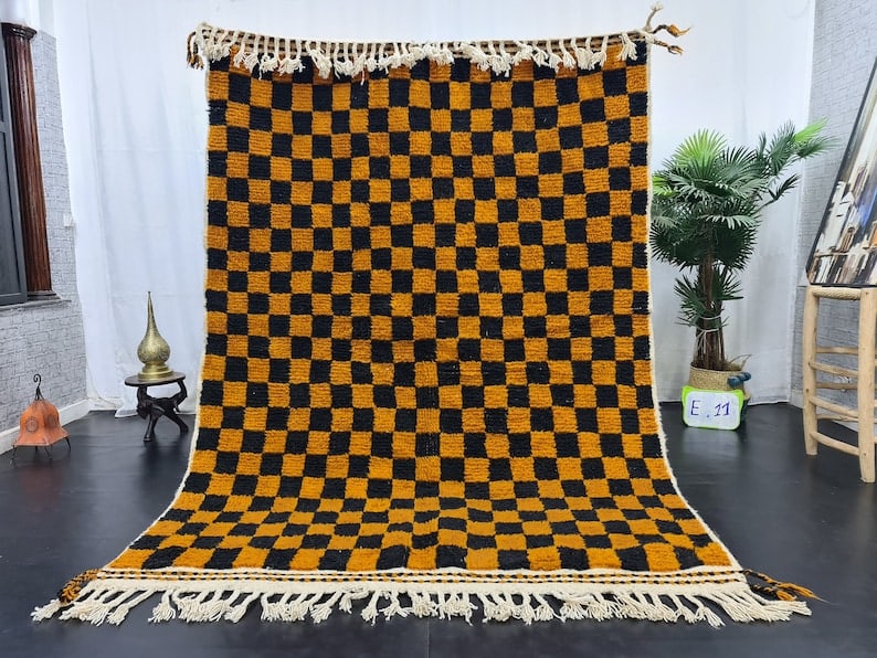 Authentic Handmade Orange Black Wool Chess Rug 8x5 Feet Morocco: Authentic Handmade Orange Black Wool Chess Rug 8x5 Feet Morocco Elevate your living space with this authentic Handmade Chess Orange & Black Wool Rug. Skillfully handwoven in the Atlas Mountains by loc
