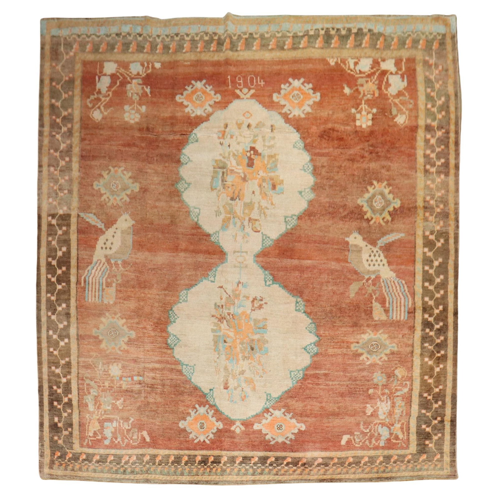 1904 Turkish Kars Wool Rug with Pigeons Folk Art 113 x 137 in: 1904 Turkish Kars Wool Rug with Pigeons Folk Art 113 x 137 in Discover a stunning early 20th-century Turkish rug, featuring a vibrant apricot field adorned with two large pigeons. Hand-woven from high