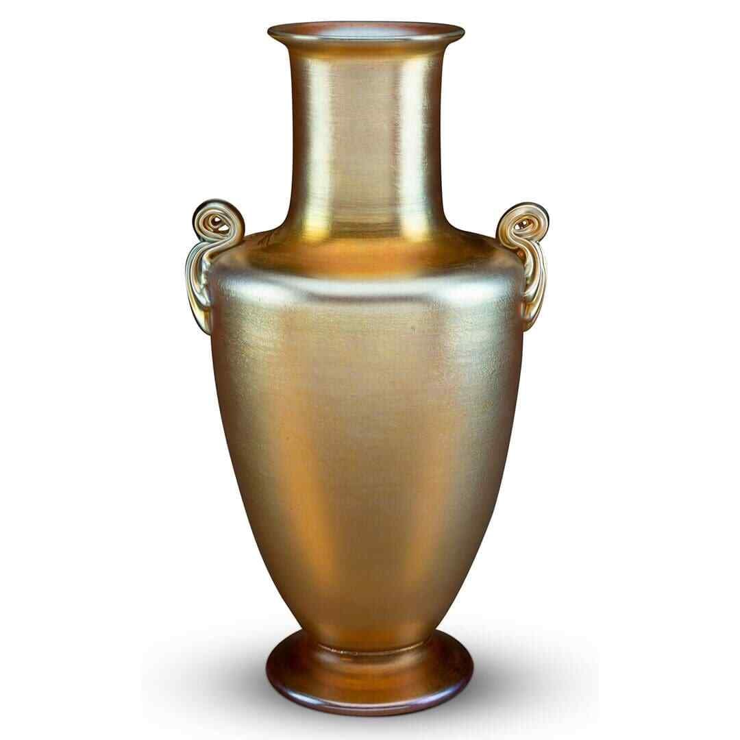 Tiffany Studios gold Favrile art vase with twin handles circa 1910: Tiffany Studios gold Favrile art vase with twin handles circa 1910 This is a Tiffany Studios Favrile glass vase from circa 1910, featuring a striking gold color and two elegantly crafted handles. The 