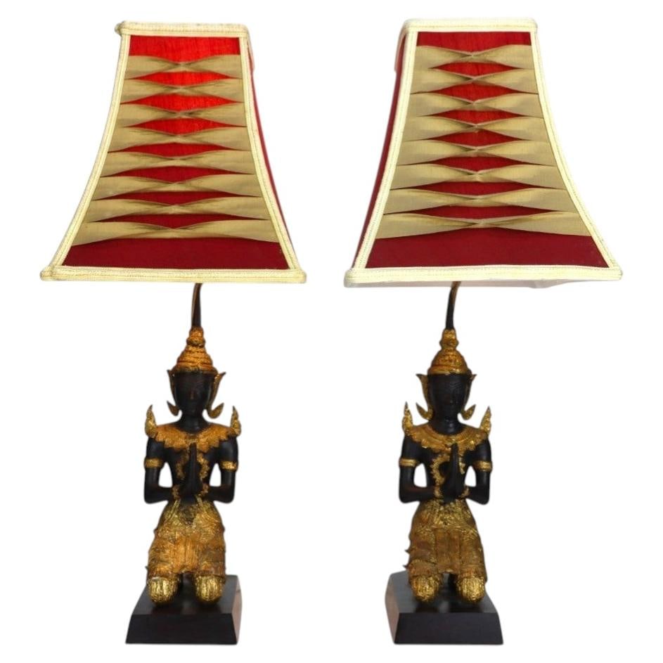 Set of 2 Thai bronze table lamps with gilt Teppanom figures c1920: Set of 2 Thai bronze table lamps with gilt Teppanom figures c1920 A pair of antique Thai lacquered and gilt bronze figural table lamps depicting Teppanom guardian angels. Each figure is shown kneeling