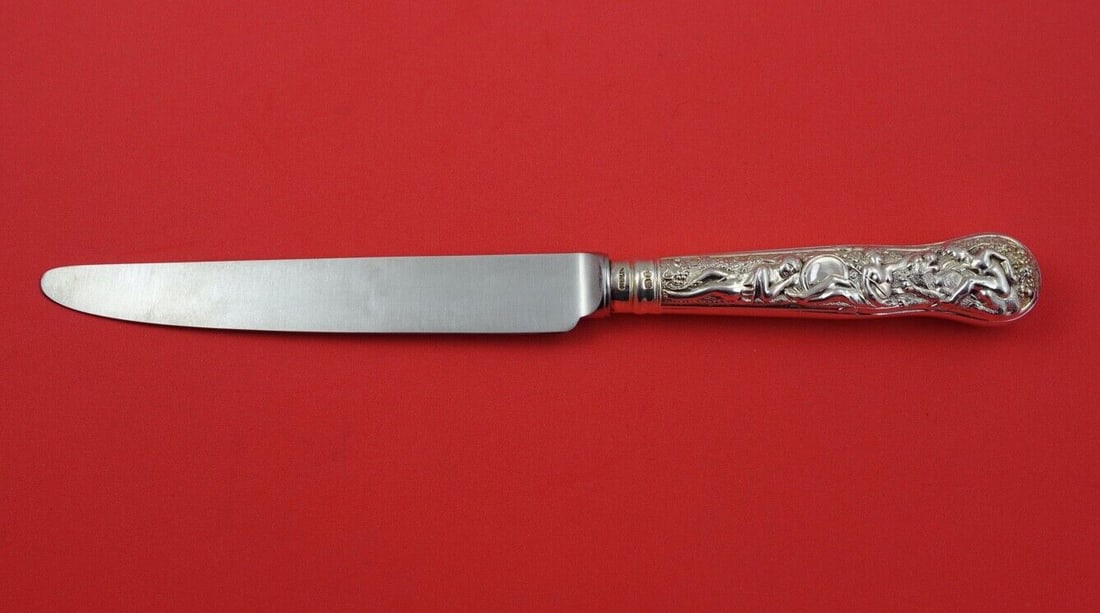 C J Vander Bacchanalian Sterling Silver Dinner Knife 10 Inch: C J Vander Bacchanalian Sterling Silver Dinner Knife 10 Inch Elevate your dining experience with this exquisite Bacchanalian dinner knife by C J Vander. Crafted from high-quality sterling silver, this