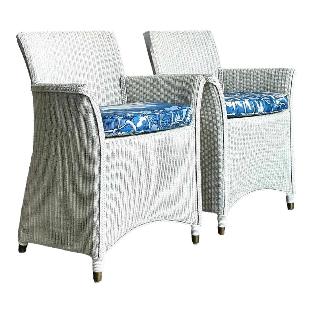 Pair of White Wicker Rattan Lounge Chairs with Floral Upholstered Cushions: Pair of White Wicker Rattan Lounge Chairs with Floral Upholstered Cushions This vintage pair of boho lounge chairs features tightly woven rattan frames finished in crisp white paint, complemented by c