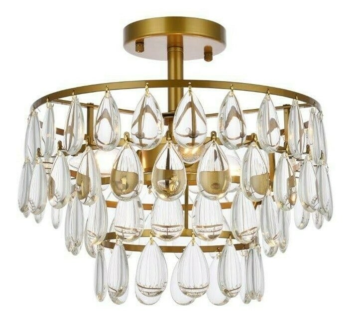 Living District Mila 3 Light Brass Flush Mount Chandelier: Living District Mila 3 Light Brass Flush Mount Chandelier This modern semi flush mount chandelier features a brass finish with high-quality glass or crystal drops, creating a stylish and elegant light