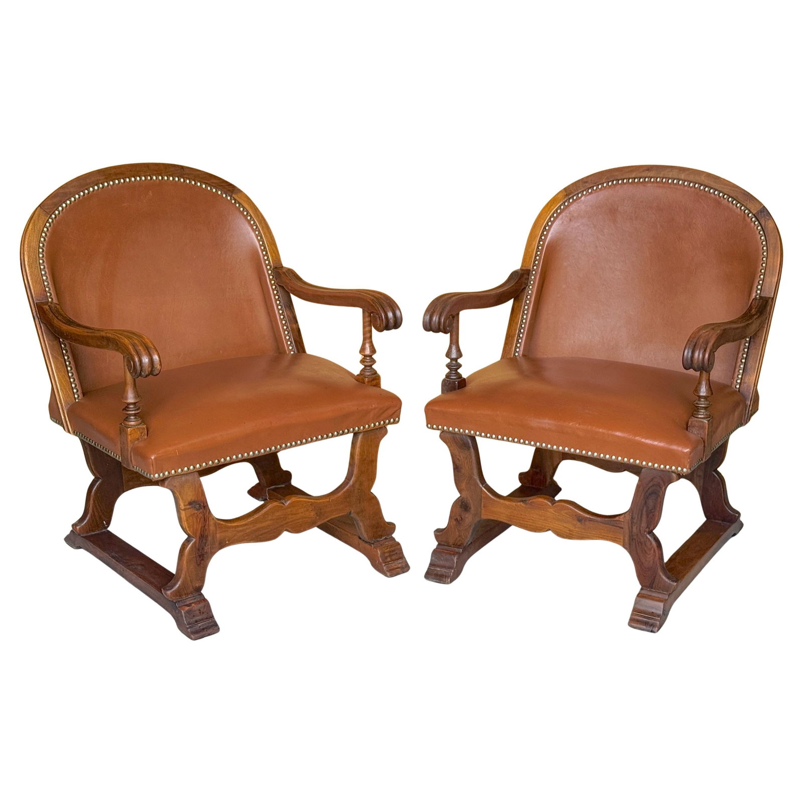 Set of 2 Spanish Walnut Leather Armchairs with Nailhead Trim 1920s: Set of 2 Spanish Walnut Leather Armchairs with Nailhead Trim 1920s This elegant pair of Spanish-style armchairs, crafted circa 1920, features solid walnut frames and rich caramel-toned leather upholst