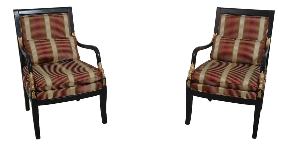Set of Two Upholstered Armchairs with Carved Dolphin Motifs Neoclassical Style: Set of Two Upholstered Armchairs with Carved Dolphin Motifs Neoclassical Style This pair of Neoclassical chairs features intricately carved dolphin arms and a striking black and gold finish. The chair
