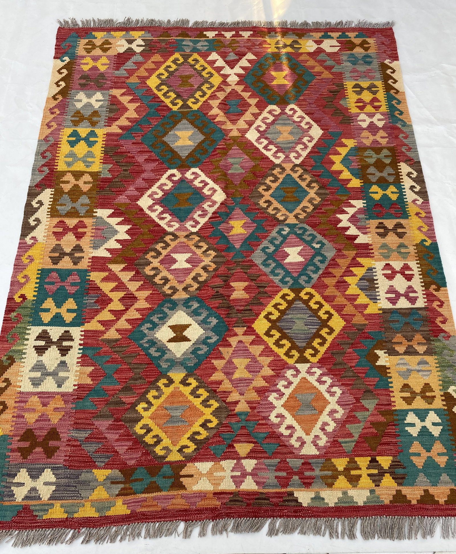 Handwoven 5x6 Multi-Color Red Geometric Kilim Rug from Afghanistan: Handwoven 5x6 Multi-Color Red Geometric Kilim Rug from Afghanistan Free continental US Shipping Add a splash of vibrant color and texture to your space with the 5' x 6' Multi-Color Red Kilim Rug. Hand