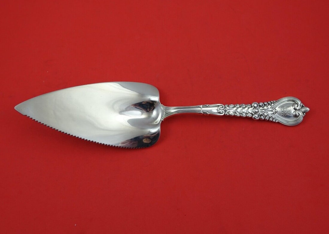 Tiffany & Co Florentine Sterling Silver 10 Inch Pie Server with Serrated Blade: Tiffany & Co Florentine Sterling Silver 10 Inch Pie Server with Serrated Blade Discover the elegance of the Florentine pattern by Tiffany & Co. This exquisite sterling silver pie server features a fla
