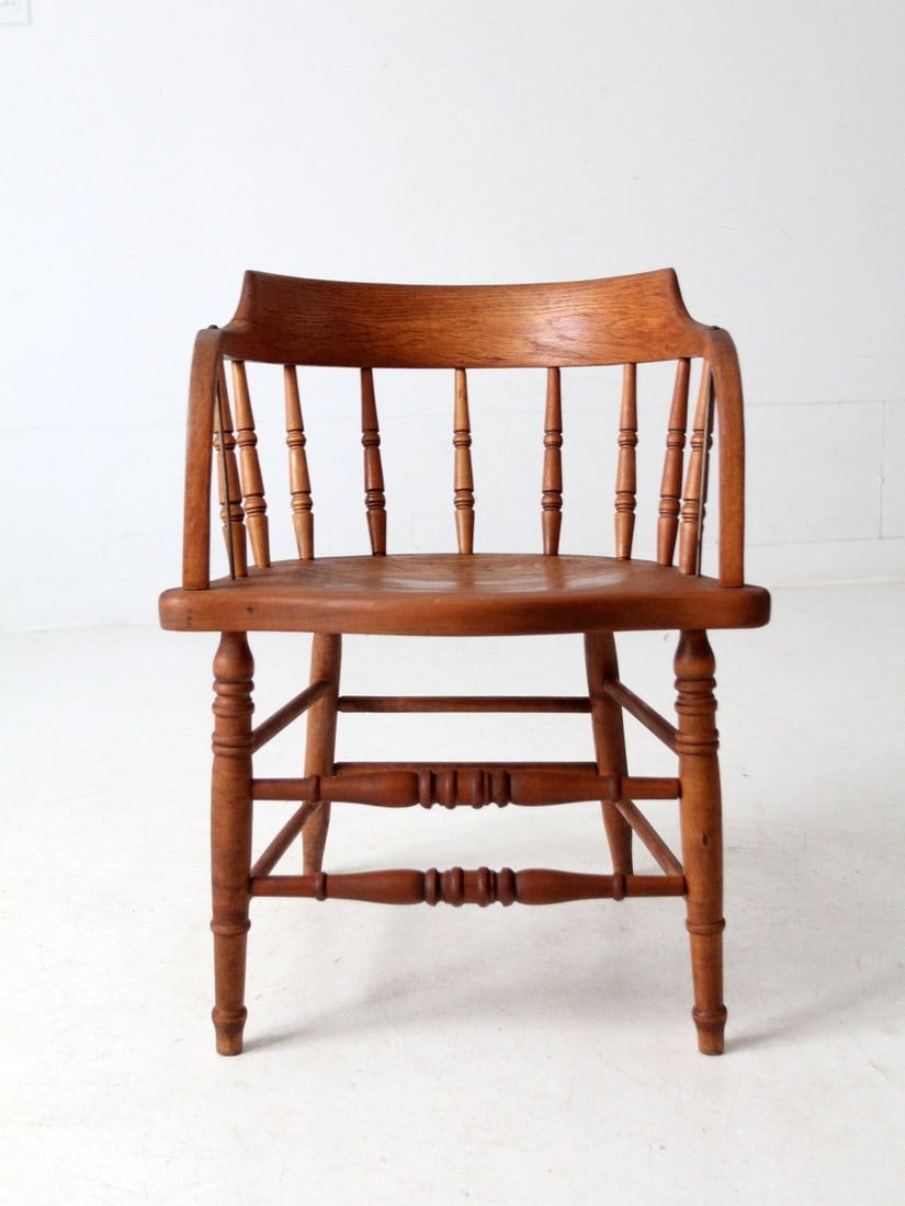 Antique Elm Wood Captain's Chair with Metal Arm Bracing: Antique Elm Wood Captain's Chair with Metal Arm Bracing Enhance your living space with this charming antique captain's chair, expertly crafted from warm elm wood and featuring sturdy metal arm bracing