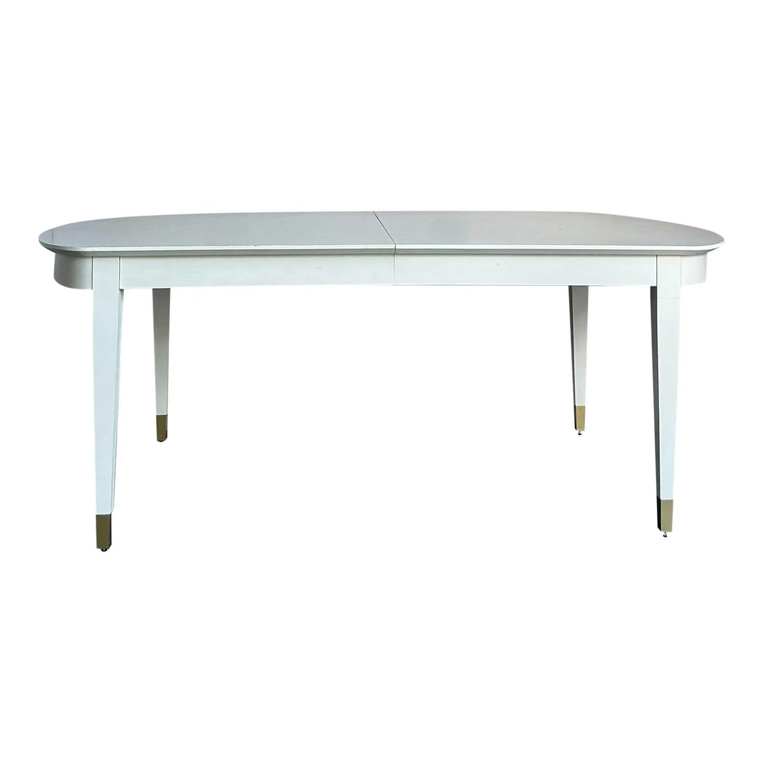 Mid-Century Modern White Lacquer Extendable Table With Brass Sabot Feet: Mid-Century Modern White Lacquer Extendable Table With Brass Sabot Feet This vintage Mid-Century Modern dining table features Danish-inspired lines with Hollywood Regency details. The boat-shaped tabl