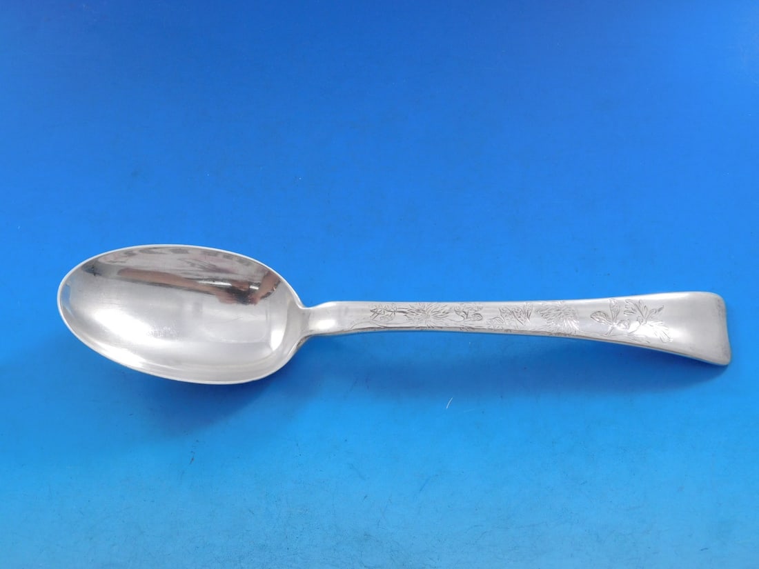 Tiffany Sterling Silver Serving Spoon Lap Over Edge Marigolds 8 5/8": Tiffany Sterling Silver Serving Spoon Lap Over Edge Marigolds 8 5/8" This exquisite serving spoon showcases the renowned Lap Over Edge pattern by Tiffany & Co., crafted from fine sterling silver. The 