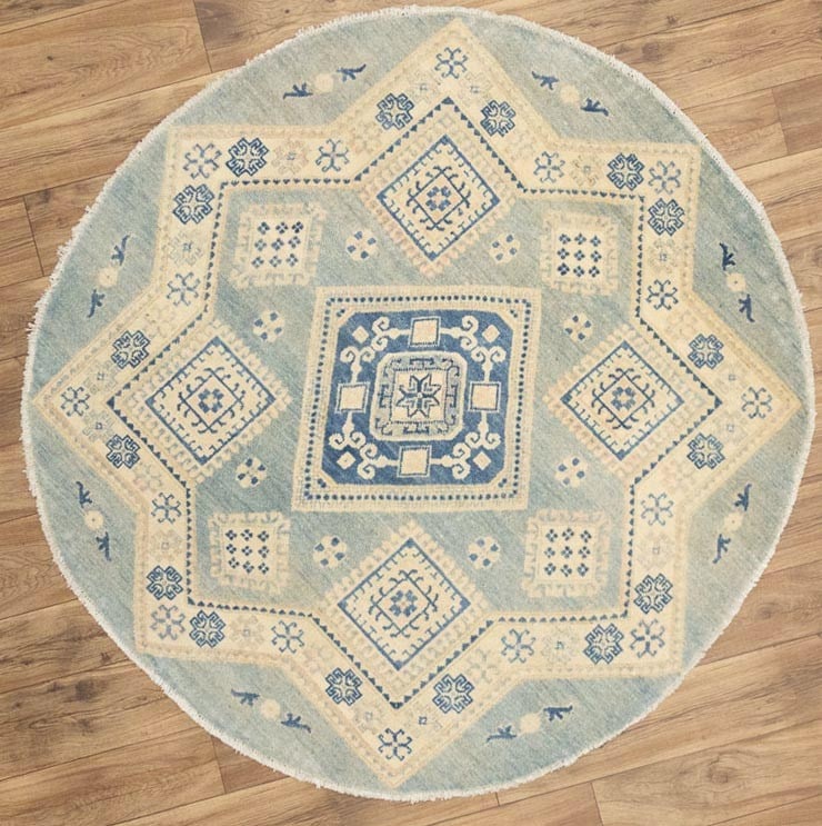 Round Hand-Knotted Wool Oushak Area Rug Muted Floral Pattern 4'10 x 4'11: Round Hand-Knotted Wool Oushak Area Rug Muted Floral Pattern 4'10 x 4'11 This handmade round Oushak-style area rug features a muted palette of light blue, cream, navy blue, and beige. Crafted from woo