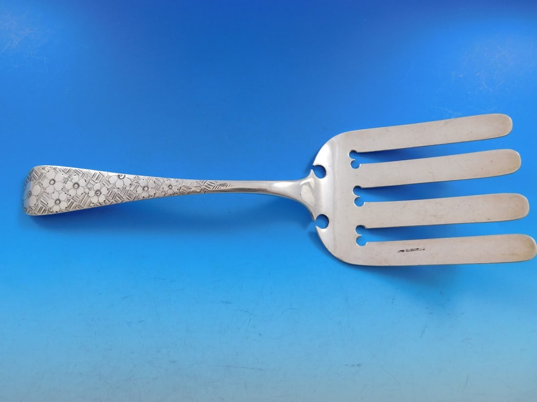 T. Wilson Brite-Cut Sterling Silver Floral Asparagus Fork 10 1/8": T. Wilson Brite-Cut Sterling Silver Floral Asparagus Fork 10 1/8" This exquisite asparagus fork by T. Wilson showcases a beautiful floral design and is crafted from high-quality sterling silver. Measu