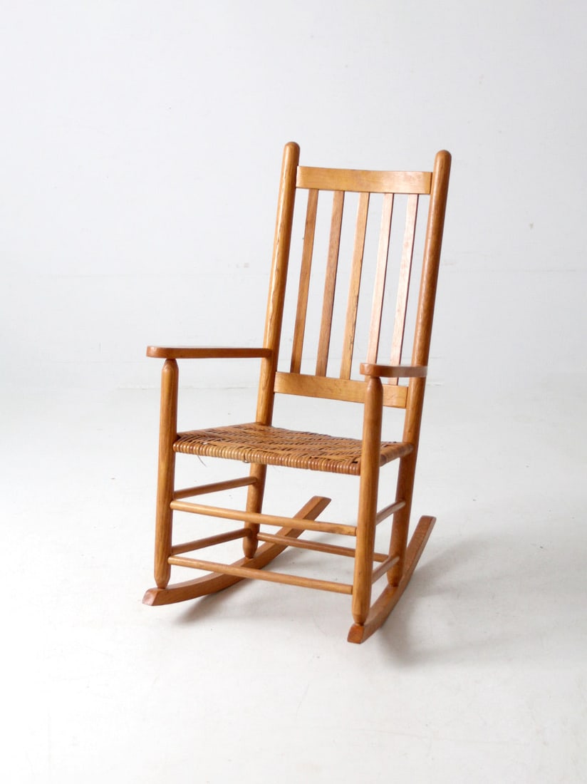 Antique Handcrafted Herringbone Rocking Chair for Cozy Spaces: Antique Handcrafted Herringbone Rocking Chair for Cozy Spaces This antique rocking chair showcases a beautifully handcrafted slat back and a woven herringbone seat, perfect for creating a cozy reading