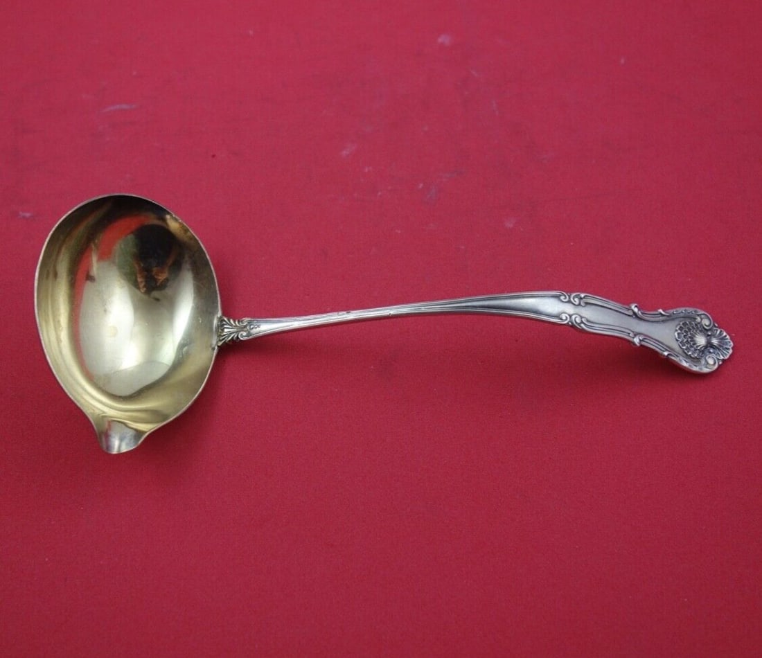 Durgin New Queens sterling bouillon ladle gold washed spout 7 1/2: Durgin New Queens sterling bouillon ladle gold washed spout 7 1/2 Sterling silver bouillon server ladle in the New Queens pattern by Durgin, featuring a spout and gold wash. It is not monogrammed and 