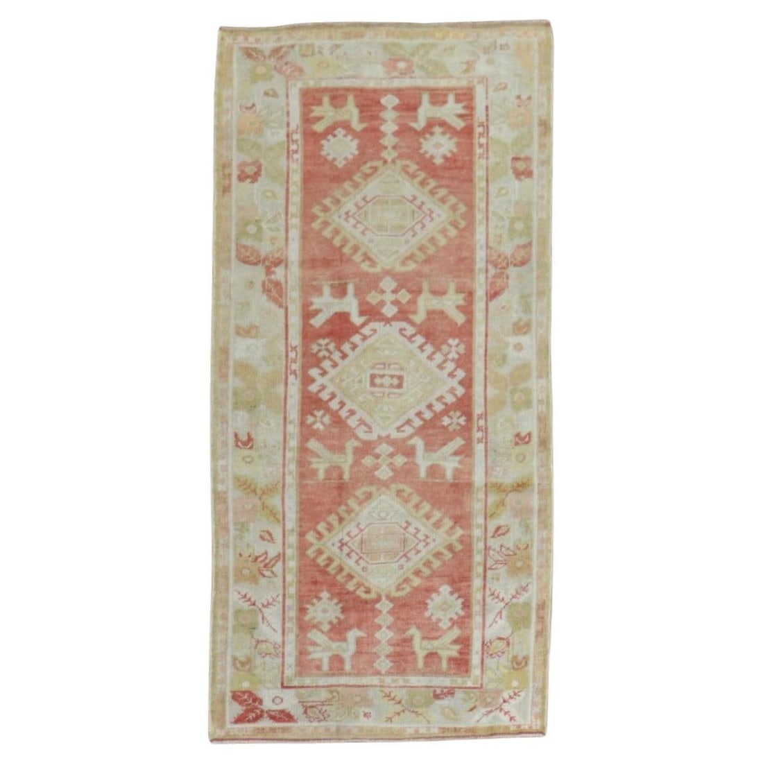 Early 20th Century Turkish Oushak Hand-Woven Runner with Pigeon Motifs: Early 20th Century Turkish Oushak Hand-Woven Runner with Pigeon Motifs This exquisite early 20th-century Turkish Oushak runner features a soft coral red color accented with a geometric design, showcas