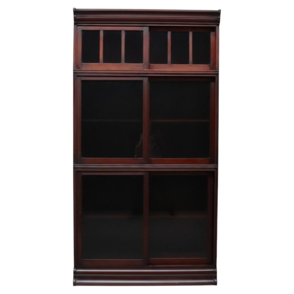 Mahogany Danner barrister bookcase with 3 sliding glass sections c1920: Mahogany Danner barrister bookcase with 3 sliding glass sections c1920 An antique Arts & Crafts barrister bookcase by Danner, crafted in mahogany and dating to approximately 1920. This three-stack cab