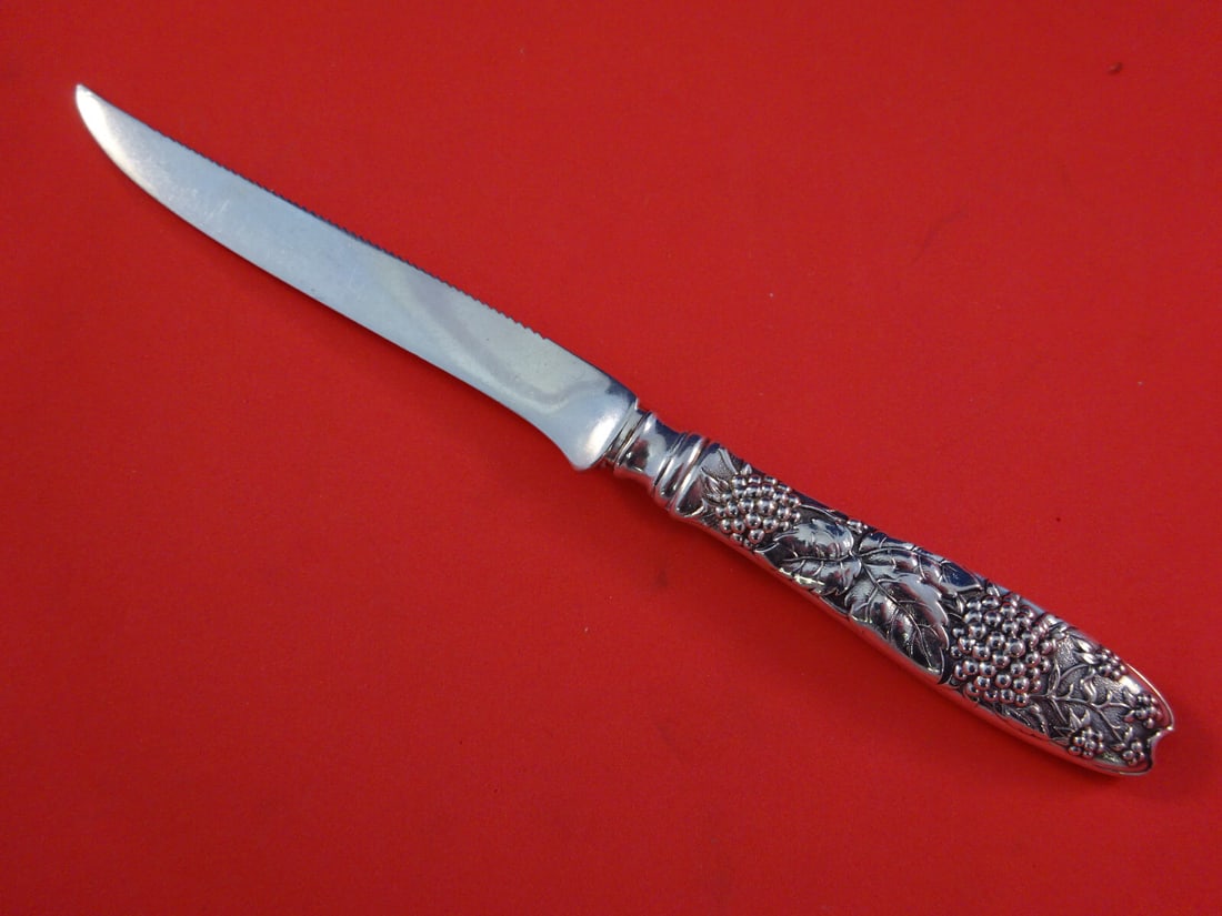 Tiffany & Co Blackberry Sterling Silver Serrated Fruit Knife 7 1/4": Tiffany & Co Blackberry Sterling Silver Serrated Fruit Knife 7 1/4" This exquisite fruit knife from Tiffany & Co. is crafted from sterling silver, featuring a serrated edge and a hollow handle design.