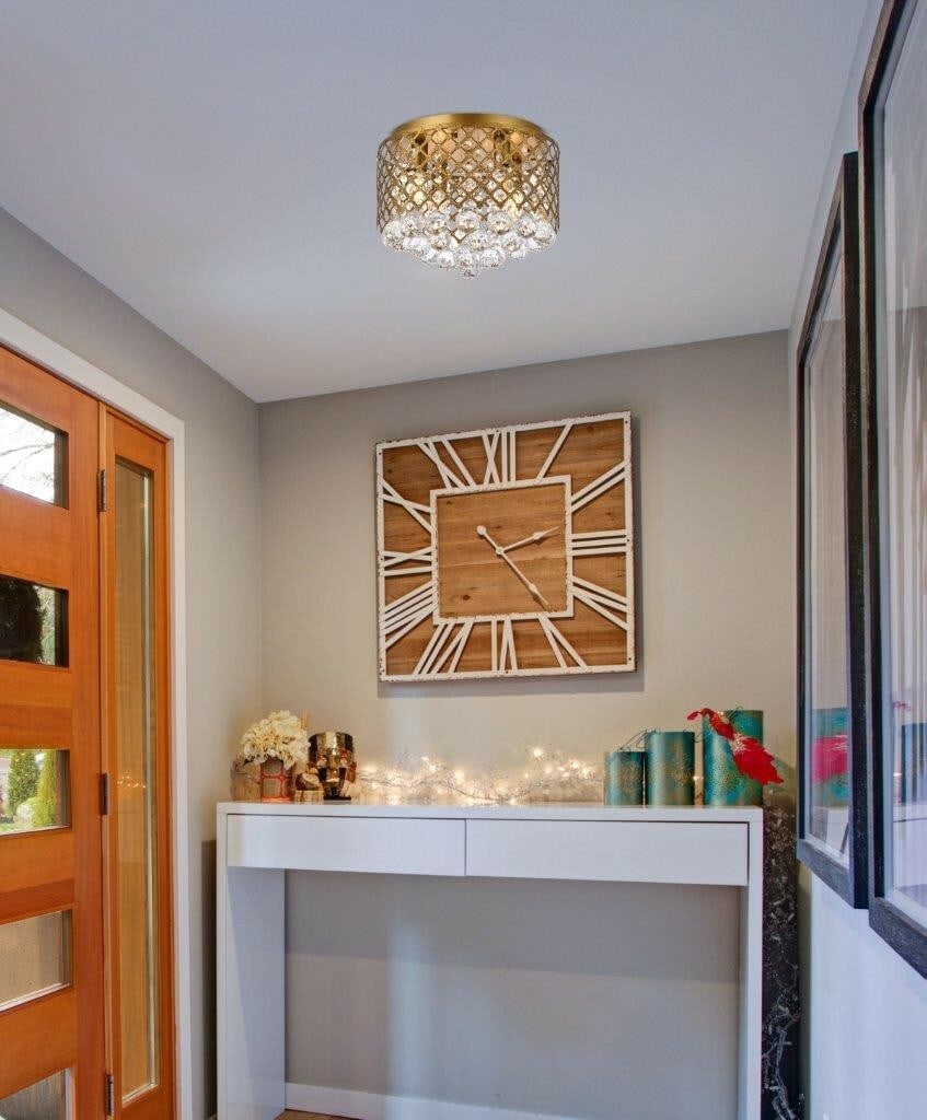 Living District Tully Brass Crystal Flush Mount 4-Light Chandelier: Living District Tully Brass Crystal Flush Mount 4-Light Chandelier This modern flush mount chandelier features a round design with a brass finish, adorned with royal cut clear crystal elements. Measur