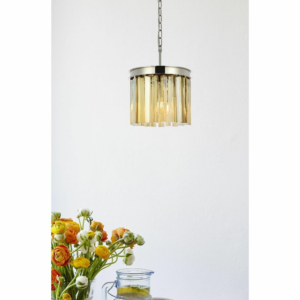 Sydney 12 in Crystal Pendant Polished Nickel 3 Light: Sydney 12 in Crystal Pendant Polished Nickel 3 Light Modern 3-light crystal chandelier pendant with a polished nickel finish and golden teak crystals. This hardwired indoor fixture measures 12 in. wid