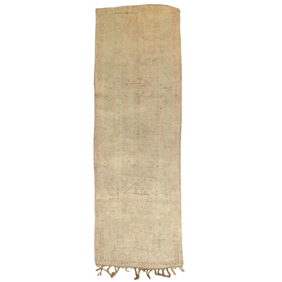 Handwoven Wool Moroccan Runner in Pink and Cream: Handwoven Wool Moroccan Runner in Pink and Cream This unique mid-20th century Moroccan runner features a hand-woven wool construction with light cream and pink accents. Dating to around 1940, it showc