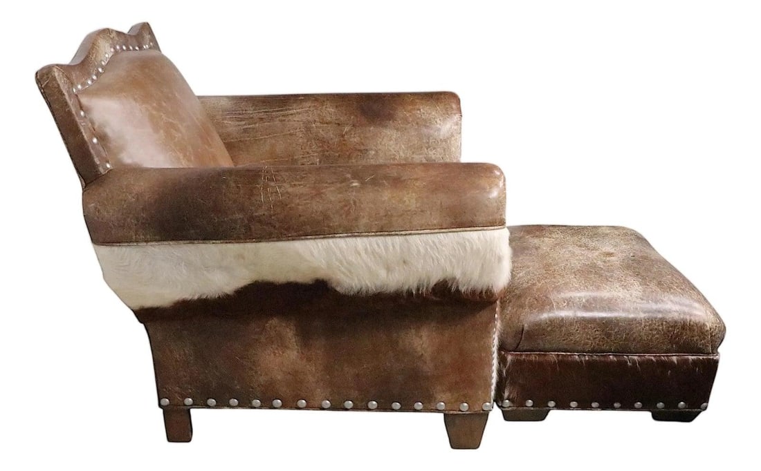 Old Hickory Tannery hide leather club chair with matching ottoman: Old Hickory Tannery hide leather club chair with matching ottoman Rustic Old Hickory hide and leather club chair with matching ottoman, upholstered in leather and fur with studded nailhead trim. The p