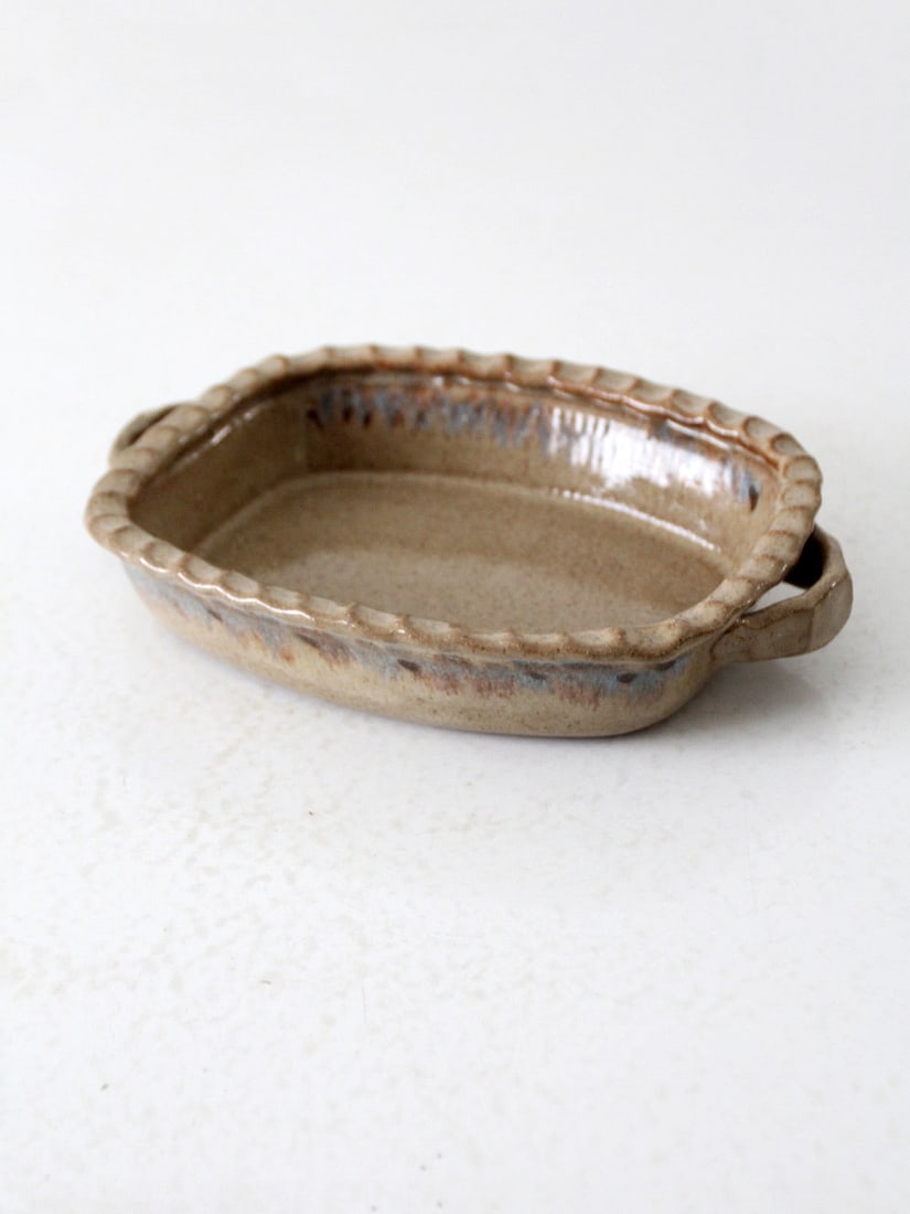 Rustic Vintage Handmade Pottery Serving Dish 9.75x7 Inches: Rustic Vintage Handmade Pottery Serving Dish 9.75x7 Inches This vintage handmade pottery serving dish features a warm taupe glaze with a charming scalloped edge, adding a touch of rustic elegance to y