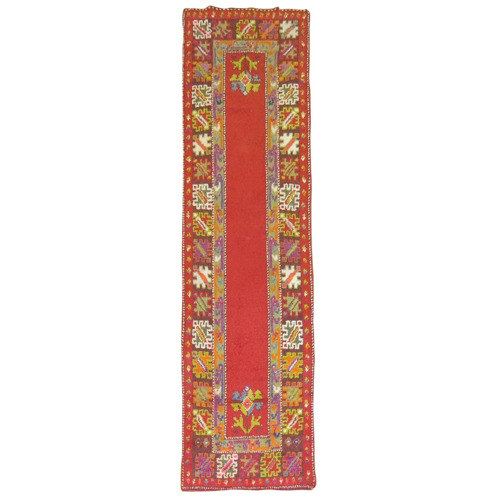 Mid Century Turkish Wool Hand Woven Tulu Runner: Mid Century Turkish Wool Hand Woven Tulu Runner This Bohemian Turkish Tulu runner from the mid-20th century features a vibrant cherry red open field accented by a colorful floral border. Hand-woven fr